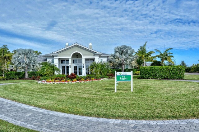 exterior space featuring a front yard and french doors