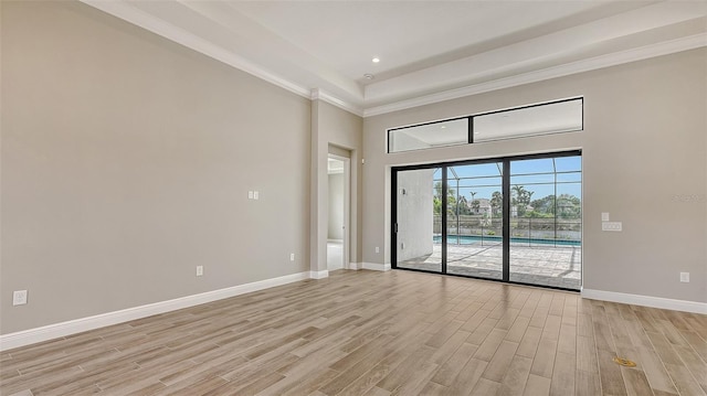 spare room featuring crown molding, recessed lighting, light wood-style flooring, and baseboards