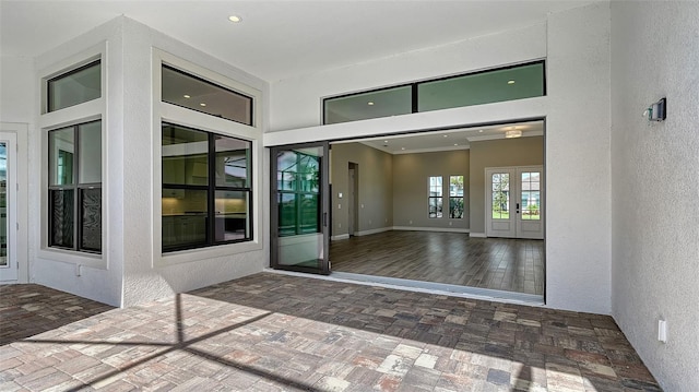 property entrance with french doors and stucco siding