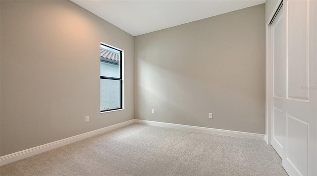 empty room with carpet flooring and baseboards