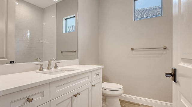 bathroom featuring wood finished floors, vanity, toilet, and baseboards