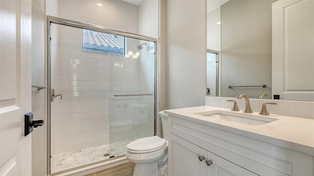 full bath with a shower stall, toilet, and vanity