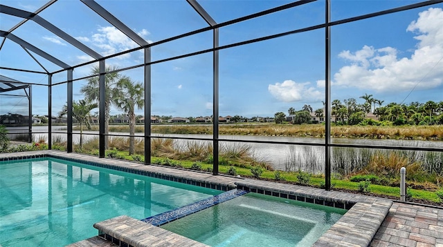 view of pool with a water view, a lanai, and a pool with connected hot tub