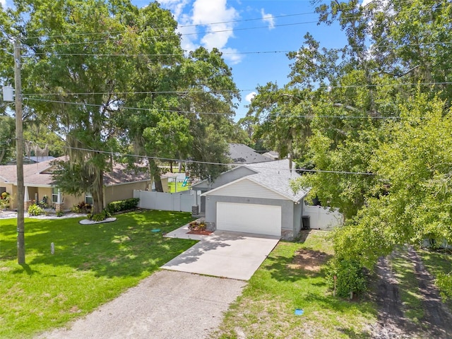 view of front of property featuring a garage and a front yard