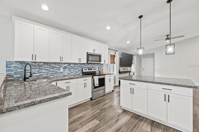 kitchen with ceiling fan, stainless steel appliances, hanging light fixtures, white cabinets, and light hardwood / wood-style flooring