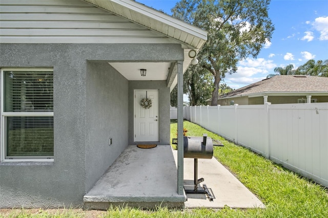 entrance to property featuring a patio area