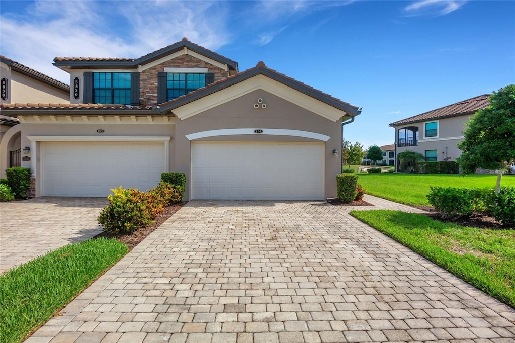 view of front of property featuring a garage and a front lawn