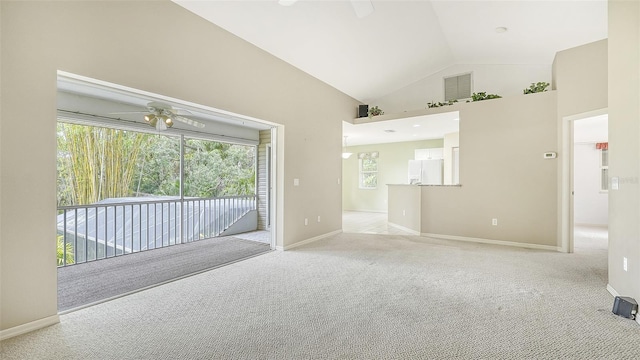 carpeted spare room featuring ceiling fan and lofted ceiling