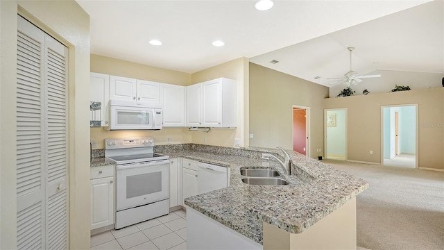 kitchen featuring sink, white appliances, light stone countertops, white cabinets, and kitchen peninsula