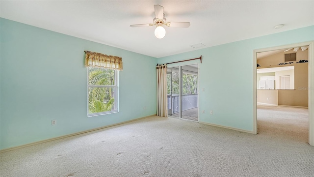 unfurnished room featuring a wealth of natural light, light colored carpet, and ceiling fan