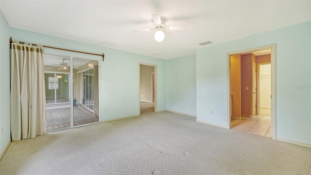 unfurnished room featuring ceiling fan and light carpet