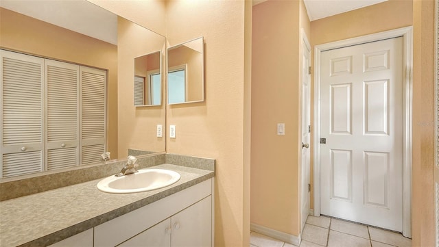 bathroom featuring tile patterned flooring and vanity