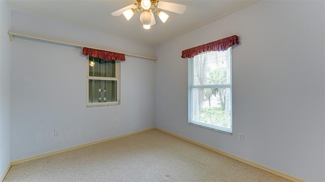 unfurnished room featuring ceiling fan and carpet