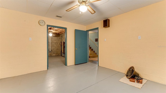 spare room with concrete floors and ceiling fan