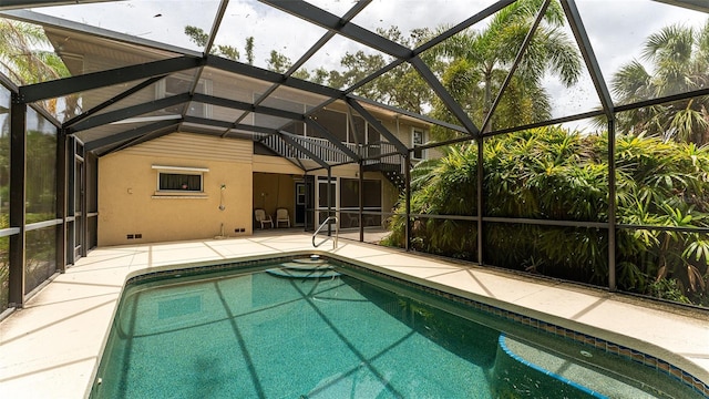 view of swimming pool with a patio and a lanai