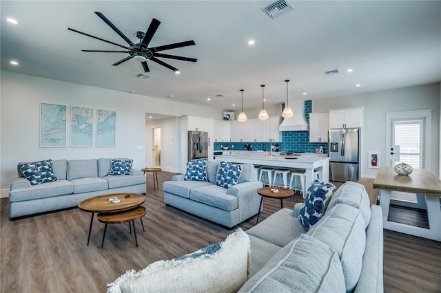 living room with light hardwood / wood-style floors and ceiling fan