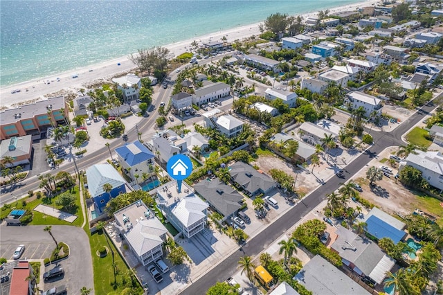 birds eye view of property featuring a water view and a beach view