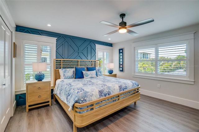 bedroom featuring ceiling fan, wood-type flooring, and a closet