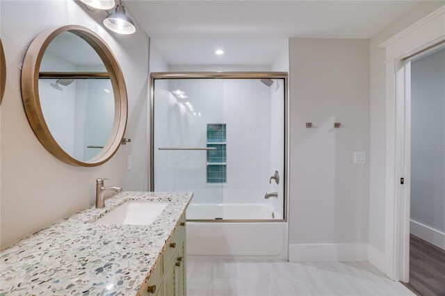 bathroom with vanity and combined bath / shower with glass door