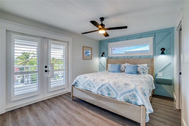 bedroom with access to exterior, ceiling fan, and wood-type flooring