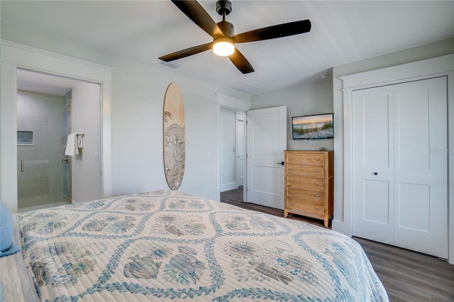 bedroom with ceiling fan, ensuite bathroom, dark wood-type flooring, and a closet