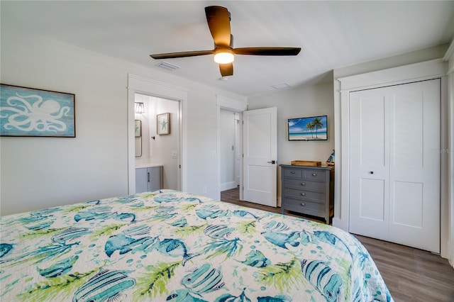 bedroom with ensuite bath, ceiling fan, a closet, and dark hardwood / wood-style floors