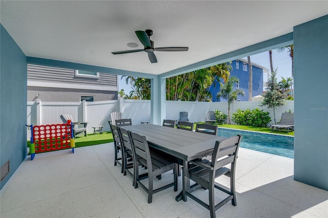 view of patio with ceiling fan and a fenced in pool