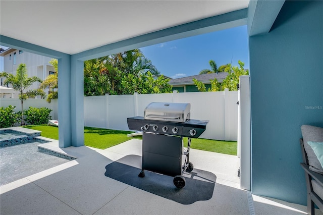 view of patio / terrace featuring area for grilling and an in ground hot tub