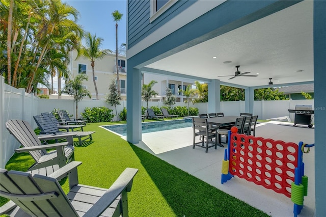 view of patio / terrace featuring ceiling fan, area for grilling, and a fenced in pool