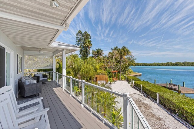 wooden deck featuring an outdoor living space, a water view, and ceiling fan