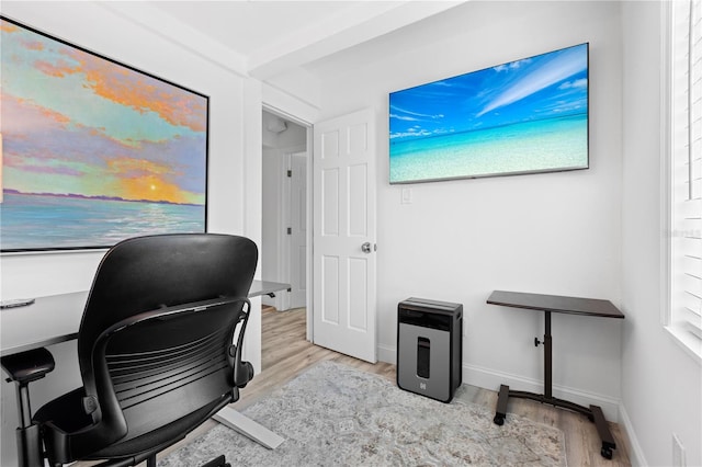 home office with light hardwood / wood-style floors