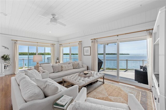 living room with light hardwood / wood-style floors, a water view, ceiling fan, and wood ceiling