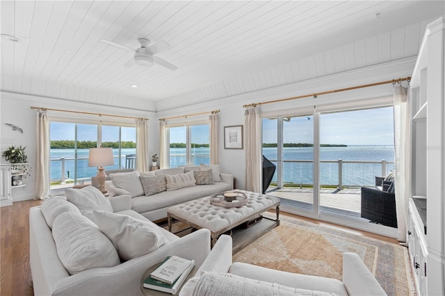 living room featuring a water view, wood ceiling, and light wood-style floors