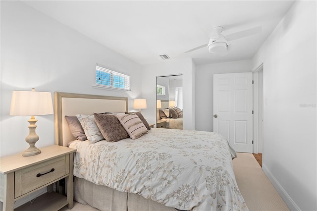 bedroom featuring light carpet and ceiling fan