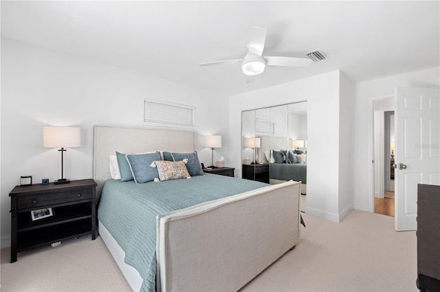 bedroom with ceiling fan, baseboards, visible vents, and light colored carpet