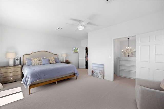 bedroom featuring light colored carpet, visible vents, and ceiling fan with notable chandelier