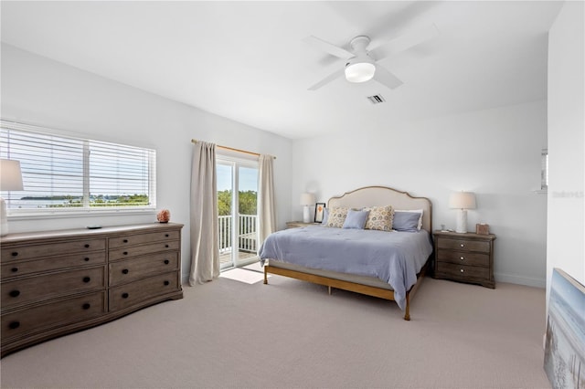 bedroom featuring access to outside, light carpet, and ceiling fan