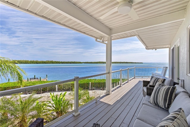 deck featuring ceiling fan and a water view