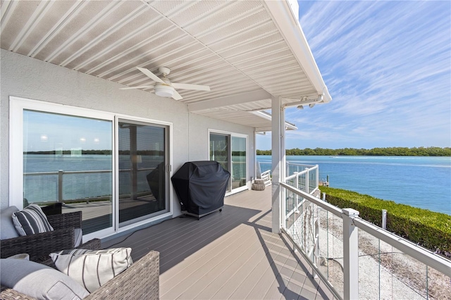 wooden terrace featuring grilling area, a water view, ceiling fan, and an outdoor hangout area