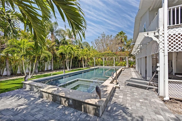 view of pool with an in ground hot tub and a patio area