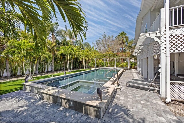 view of pool featuring an in ground hot tub