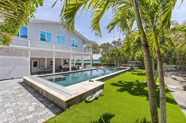 pool featuring fence, a lawn, and a patio