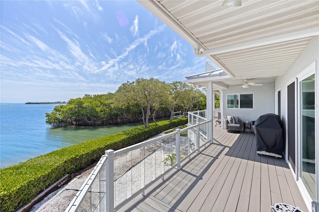 wooden terrace featuring a water view and an outdoor hangout area