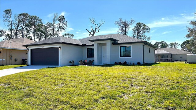 view of front of house featuring a garage and a front lawn