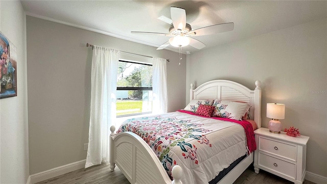 bedroom with ceiling fan and dark hardwood / wood-style flooring