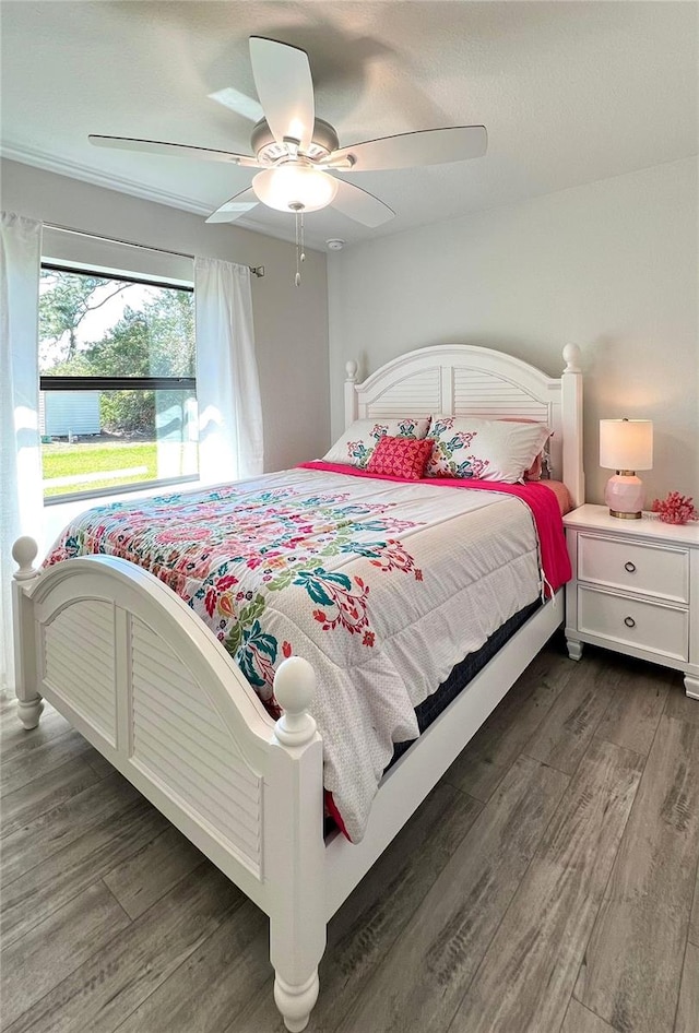 bedroom featuring dark hardwood / wood-style flooring and ceiling fan