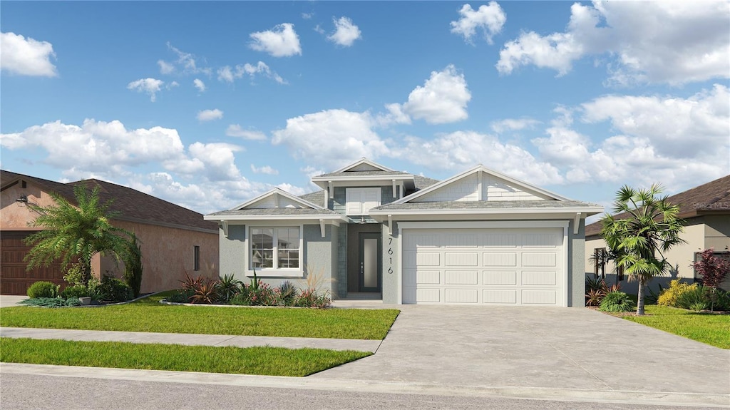 view of front of home with a front yard and a garage