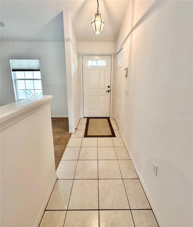 doorway to outside with light tile patterned flooring