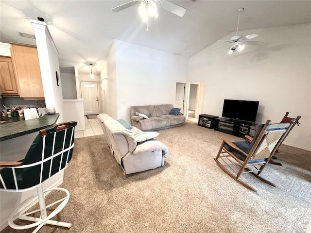 living room with high vaulted ceiling, light colored carpet, and ceiling fan