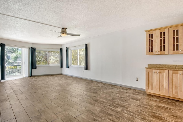 interior space with a textured ceiling and ceiling fan